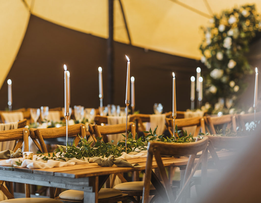 Rustic trestle table settings for wedding inside the Carlton Manor tipi