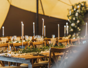 Rustic trestle table settings for wedding inside the Carlton Manor tipi